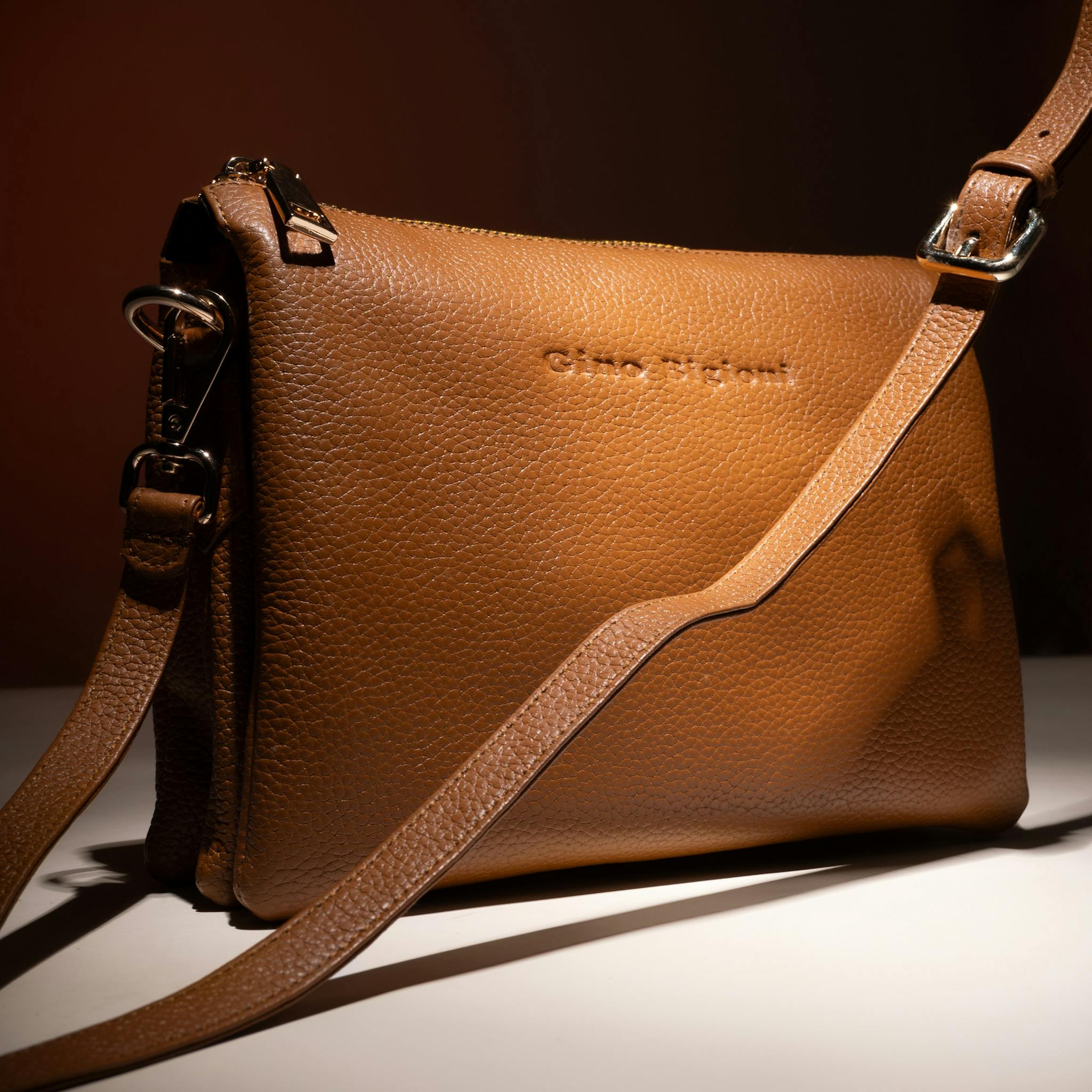 Stylish brown leather handbag with adjustable strap, perfect for fashion statements.